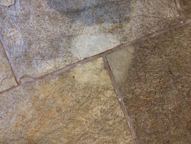 Clean spot on dirty stone floor
