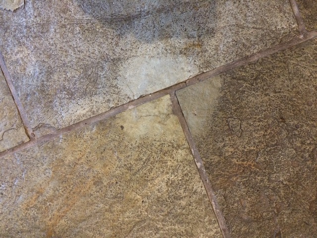 Clean spot on dirty stone floor